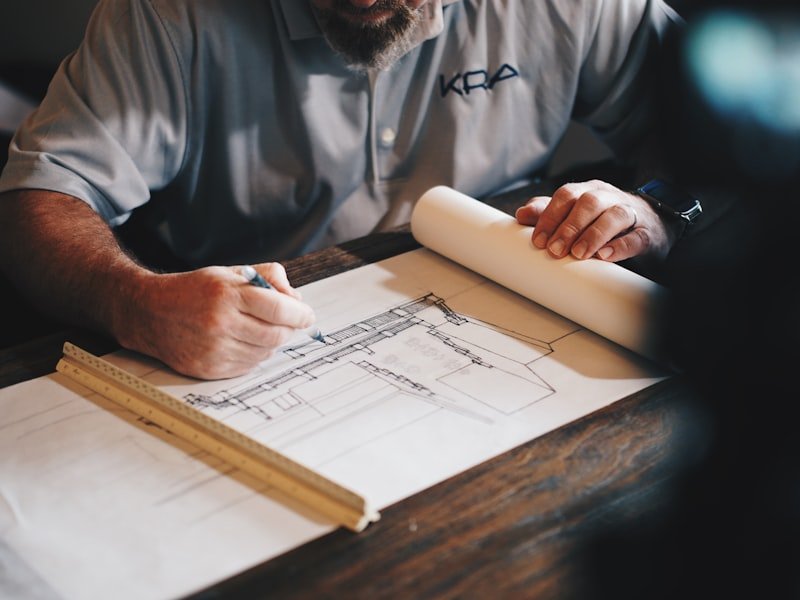 Founder at the drafting table planning a woodworking project at the Ottawa studio
