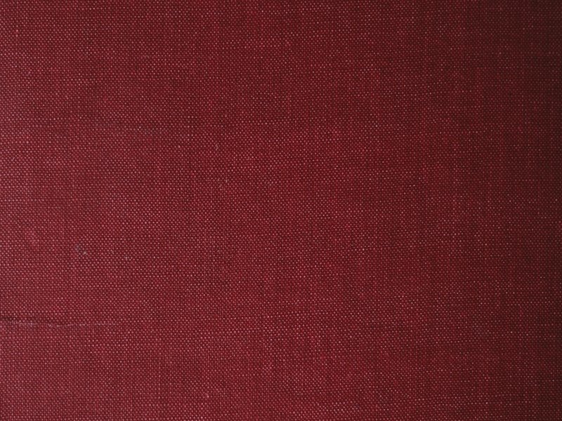 Close-up of deep-red woven textile fabric from the fibre arts studio